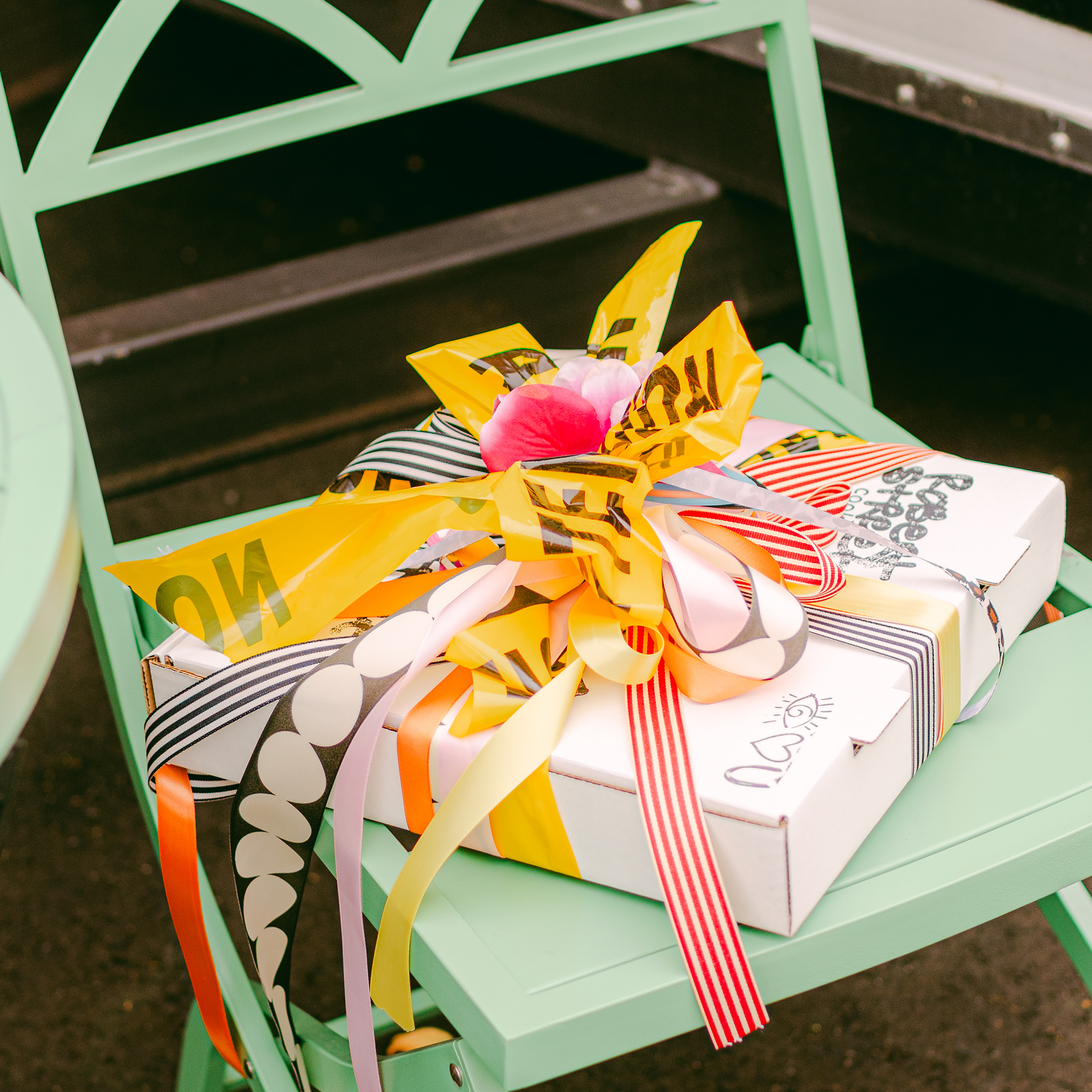 Gift wrapped box of cookies on a green chair