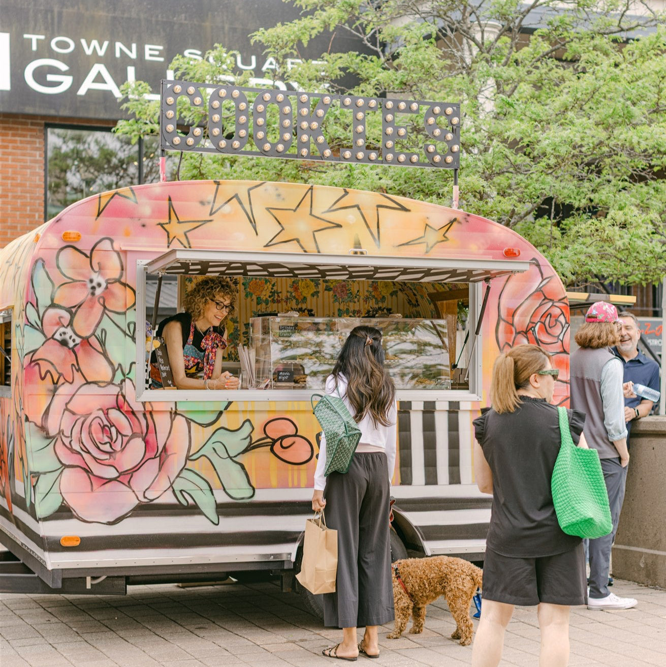 Colorful food truck with floral designs in a public area
