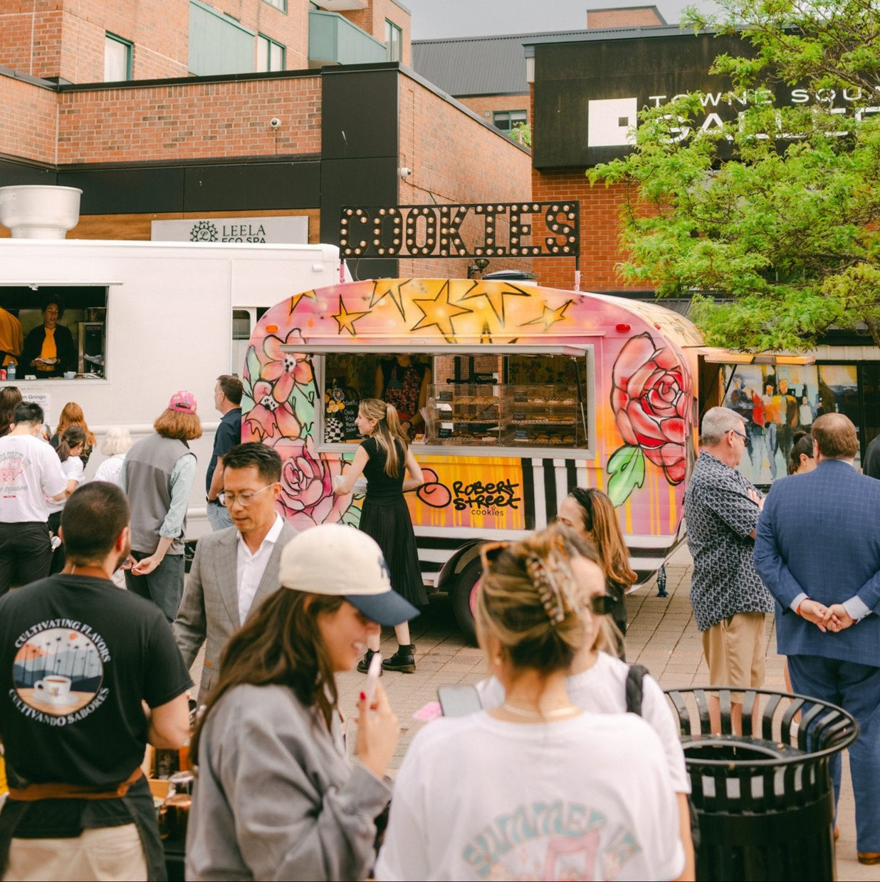 Food truck with colorful design in an urban setting with people around